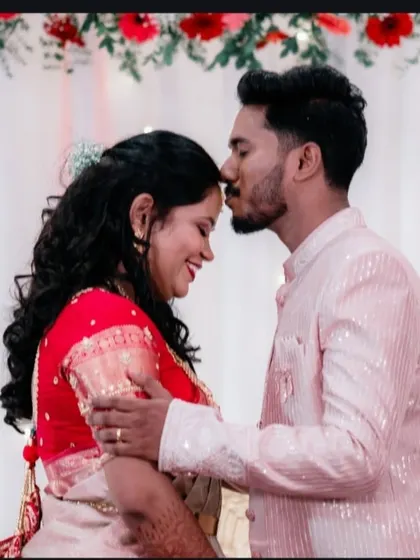 A tender moment from a reception, where the groom kisses his bride's forehead. These are the sweet, emotional candids that truly tell your love story.