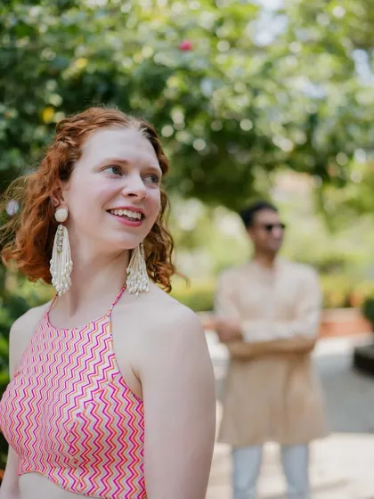 A playful shot showing the bride's chevron-patterned pink halter top, part of her custom welcome outfit that was designed to be both stylish and comfortable.