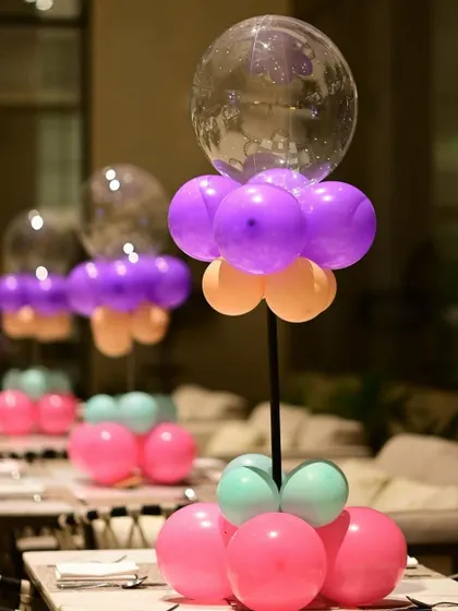 These balloon centerpieces are perfect for decorating guest tables. They add a pop of color and fun to the dining area and can be customized to match any theme.