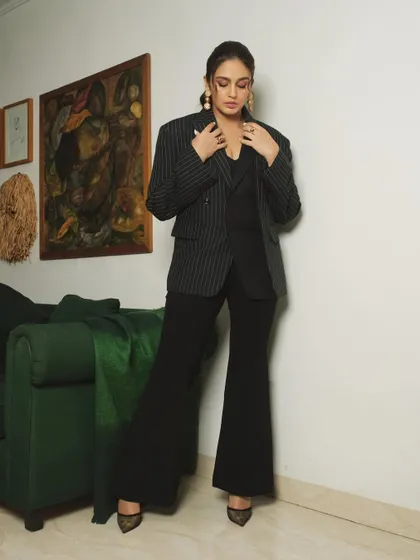 This shot captures a more posed, fashion-forward moment, with the subject adjusting her blazer.