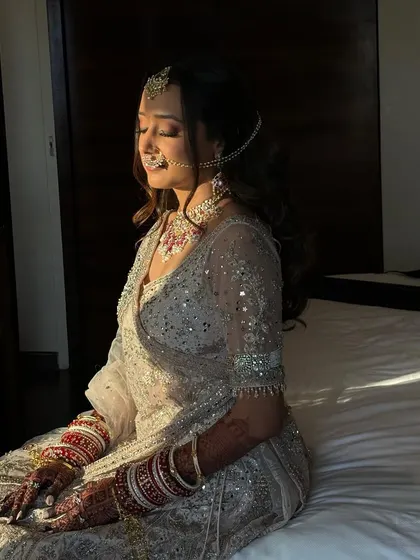 Bathed in the golden hour light, Tanvi's makeup looks absolutely flawless. The warm light enhances her dewy skin and the soft shimmer on her eyes.