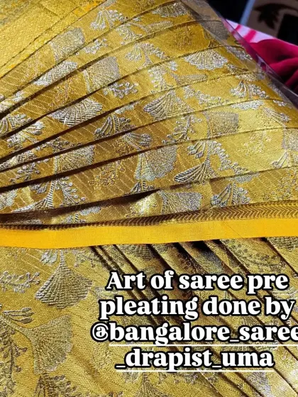 A close-up of the perfectly arranged pleats on a yellow silk saree. This level of detail is what I strive for in my pre-pleating service.