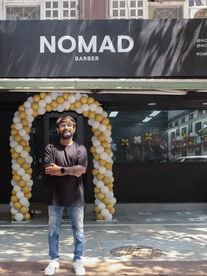 Proudly standing outside my dream come true, Nomad Barber Mumbai. It was a crazy journey to build this place, and I'm excited to welcome you here.