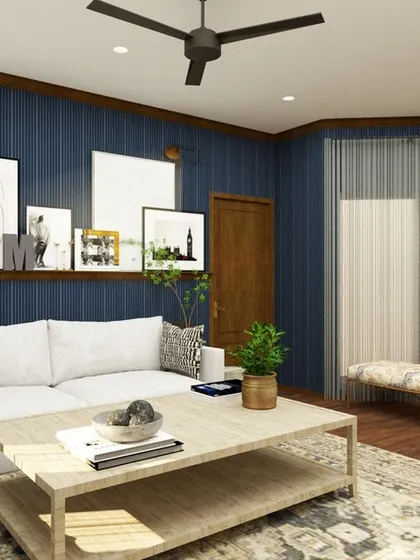 Another angle of the moody blue entertainment room, showing the large sectional sofa and the bay window with additional seating. It's a versatile space designed for gathering with family and friends.