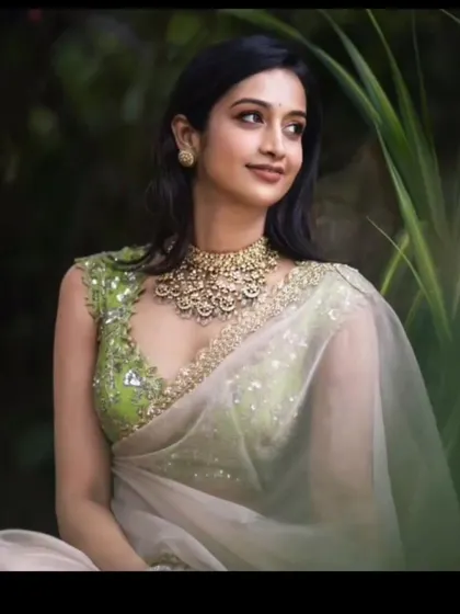 A beautiful, soft glam look for an outdoor event. The makeup enhances her features without being overpowering, perfect for this modern, sheer saree.