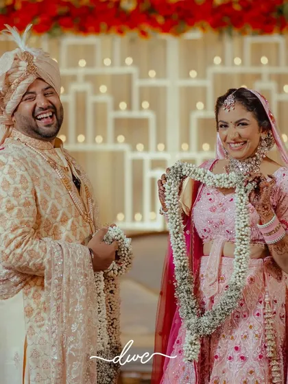 The playful side of the Jaimala ceremony, with the couple sharing a laugh after successfully exchanging garlands.