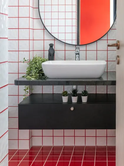 The whimsy of red and white grid tiles turns this bathroom break into a joyful dance of color. This playful retreat, part of a 4-bedroom Mumbai apartment, is every young girl's dream.