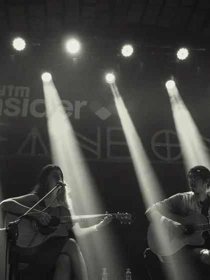 A dramatic black and white shot of our duo performance, with spotlights cutting through the darkness.