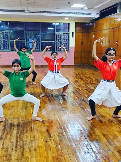 Young girls in a school workshop learning the strong, grounded stances of Mayurbhanj Chhau.