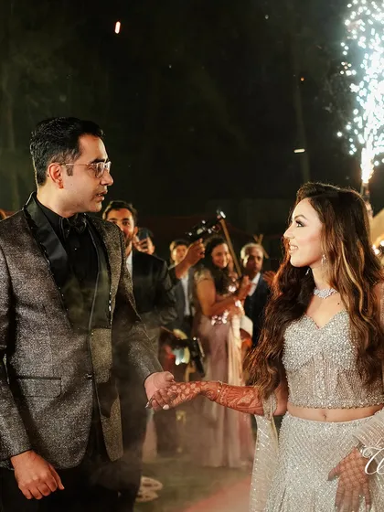 The couple making a grand entrance at their Sangeet, complete with cold pyrotechnics.