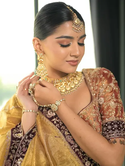 This pose captures the soft, romantic feel of the makeup. The peachy tones on the eyes and cheeks give a warm and ethereal glow.
