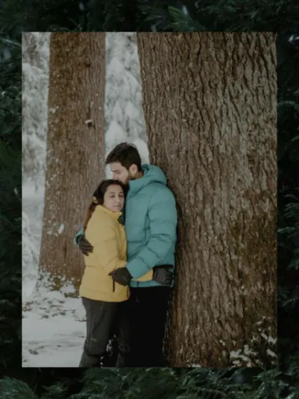 A quiet, intimate embrace against a tree in a snowy forest. Even in a grand landscape, we focus on the small, tender moments.