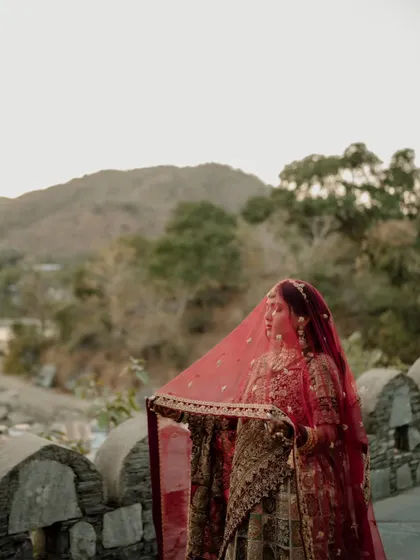 Love in its purest form. The bride, veiled against the backdrop of a palace, looks ethereal and timeless, a moment of quiet beauty before the ceremony.