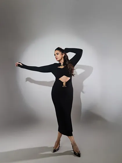 Movement and energy. This shot captures Huma in motion, showing how the dress moves with the body while maintaining its powerful silhouette.