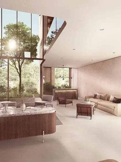 Another view of the living space in The Nest's vertical villa. A custom marble and wood console table anchors the room, while large windows frame views of the internal courtyard and the greenery beyond.