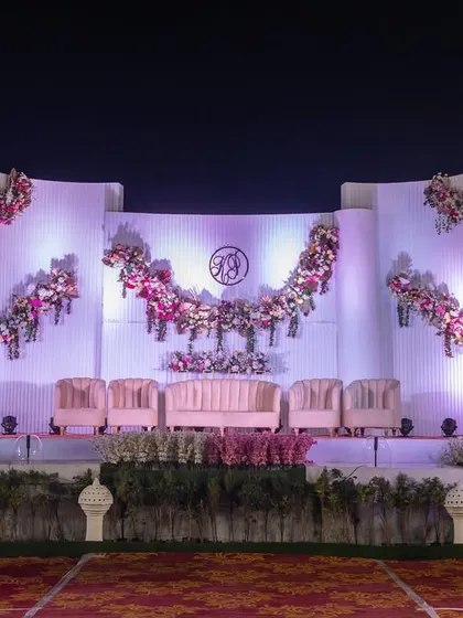 A wider view of the elegant reception stage, showing how the lighting and structure create a stunning focal point within the venue.