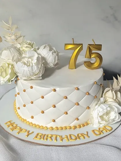 Marking three-quarters of a century with this sophisticated white and gold cake. It features a quilted fondant pattern with gold bead details and is finished with beautiful white peonies.