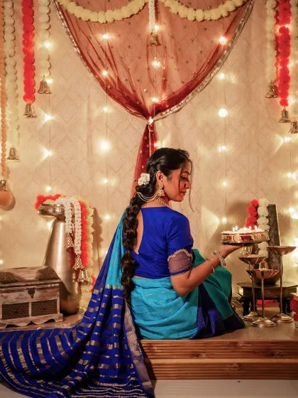 A back view of my Deepavali look, showing the beautiful drape of the Mysore silk saree and my traditional braided hairstyle with flowers. The rich blue pallu has beautiful gold stripes.
