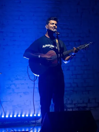 A full-length shot from my performance at AntiSocial. It shows the simple, focused setup of my solo gigs: just me, my guitar, and the stage.