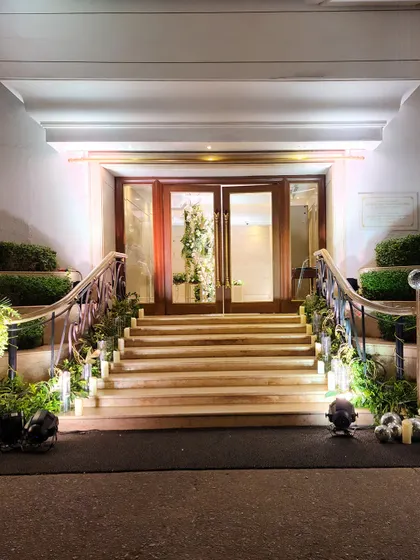 We transform every part of the venue, including staircases. This grand staircase is lined with fresh greenery and subtle uplighting, creating an elegant path for guests.