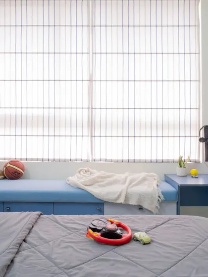 A close-up of the window seat, a perfect multi-functional spot in a child's bedroom.