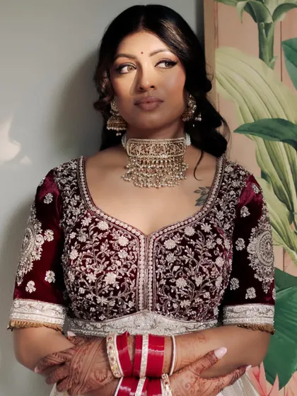 The complete look, with the rich velvet of her blouse contrasting beautifully with her luminous skin.