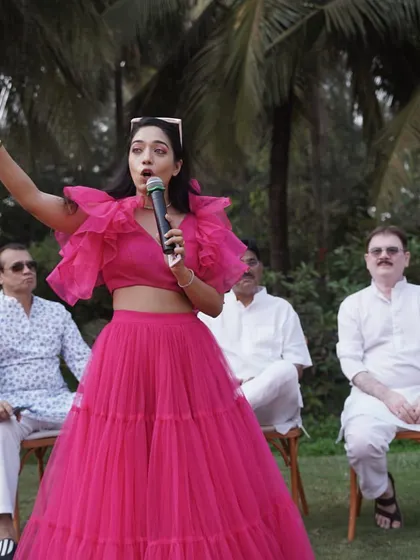 Dressed in a vibrant pink outfit, captured in action while hosting an outdoor event. I believe in the mantra: "Quit talking and begin doing."