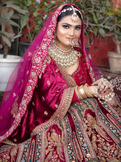 For this bride's velvet maroon lehenga, I created a rich, glamorous look with deep-set eyes and a bold lip, ensuring her makeup was as luxurious as her outfit.
