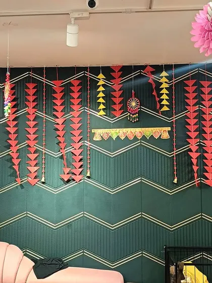 A detail shot of a decorated wall, featuring geometric paper hangings that match the store's modern aesthetic.