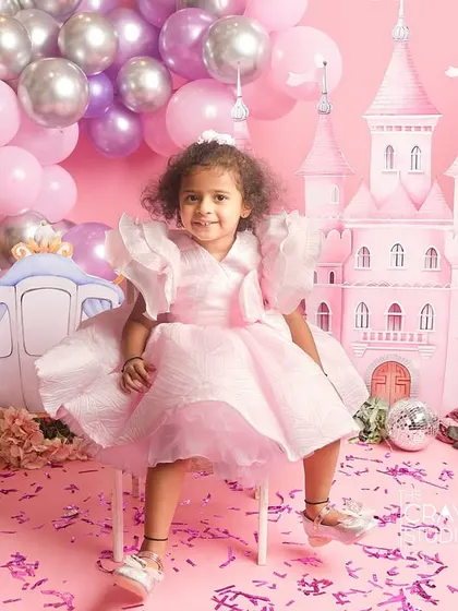 A princess takes her throne. A confident and cute pose from this little girl in her pink castle.