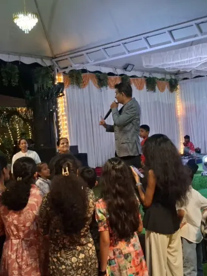Calling all kids to the front for the next activity. I make sure to gather the children and create a focal point for the entertainment so parents can relax and watch.