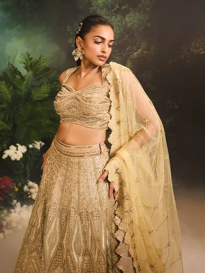 The Jade Lehenga Set, a vision in gold. The intricately adorned blouse and flowing lehenga are designed for weddings and festive celebrations alike.