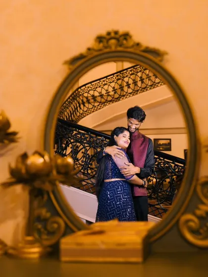 A creative shot using a mirror to reflect the couple's embrace. This adds an artistic and intimate layer to the photograph.