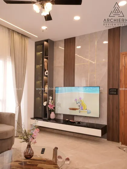 A living room TV unit with a combination of marble-finish and fluted wood panels, creating a textured and modern focal point.