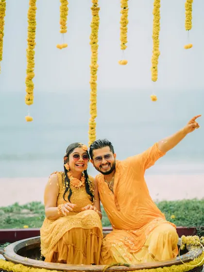 A happy, candid moment of the couple during their beachside Haldi ceremony.