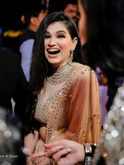 A moment of pure, uninhibited laughter. This candid shot from an engagement party perfectly captures the bride-to-be's happiness and the celebratory mood.