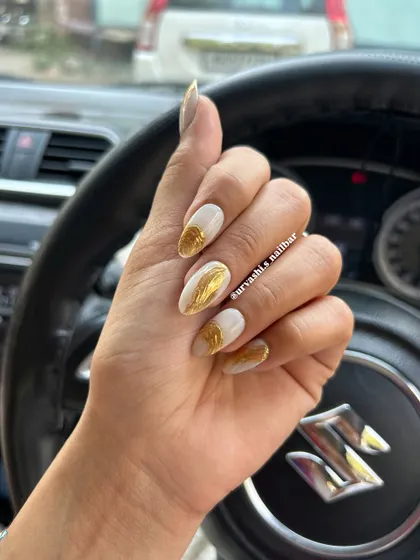 A striking design featuring a matte white base with textured gold chrome accents. The contrast between the simple white and the metallic gold creates a modern and luxurious look.