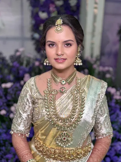 Another beautiful portrait of Sushmitha, her makeup looking fresh and flawless against the floral decor.