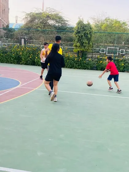 A junior player dribbles the ball while looking for an open teammate.