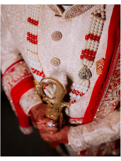 Duplicate of image 348, a close-up of the groom's attire.
