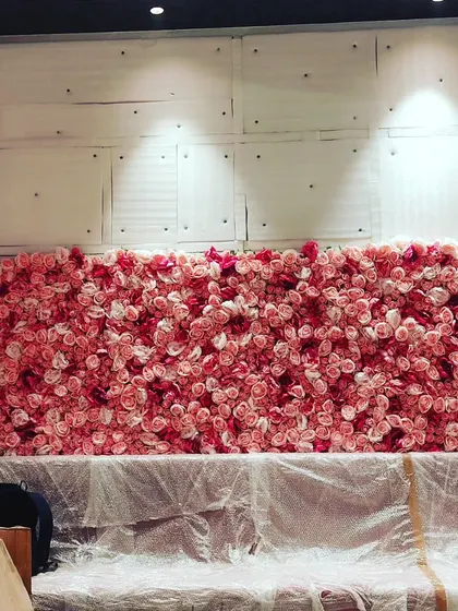 This is an artificial pink rose flower wall I was setting up for an event. These make for a very popular photo backdrop at weddings, birthday parties, and bridal showers.