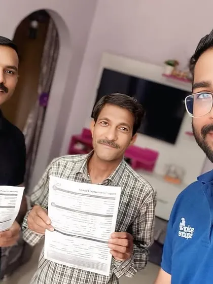 Our team with a customer holding his new solar agreement. We are dedicated to making the switch to solar seamless.