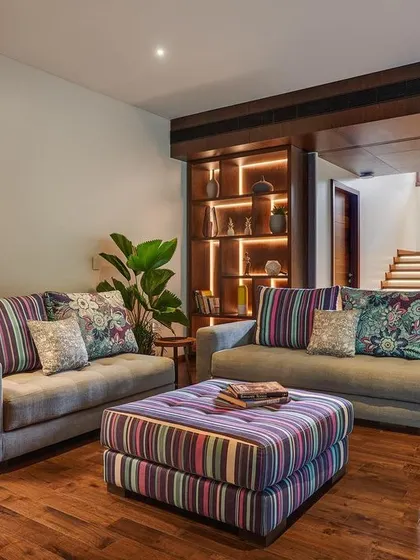 The upstairs family lounge in the Kanasu home. We used colorful soft furnishings to add a playful touch to the neutral palette of white walls and hardwood floors.