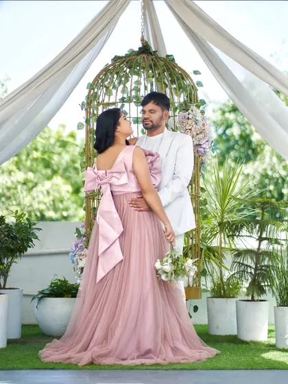This photo showcases the beautiful back of the 'Bloom' gown, featuring a large, elegant bow that adds a surprising and delightful detail. It's perfect for photos from every angle.