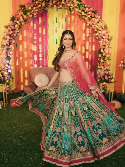 The bride twirls in her magnificent multi-colored lehenga, a perfect shot to capture the grandeur of her Sangeet outfit.