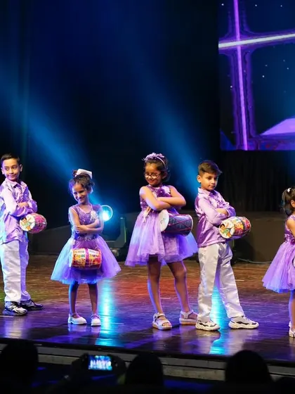 The full group of our youngest Bollywood stars, posing confidently with their drums on stage.