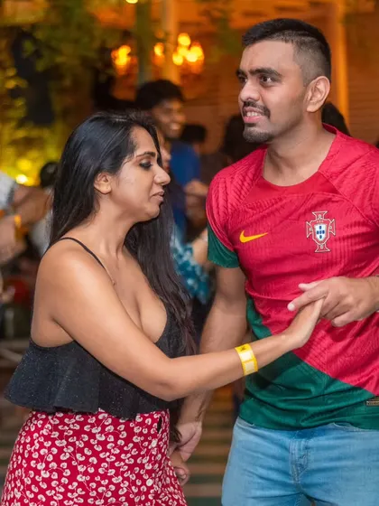 Even in a football jersey, the salsa spirit is strong. Our students bring their passion everywhere, including the social dance floor.