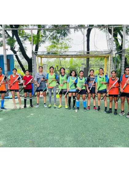 Our girls' team lines up with their sticks ready at the start of a practice session. We instill discipline and focus from the very first minute of training.