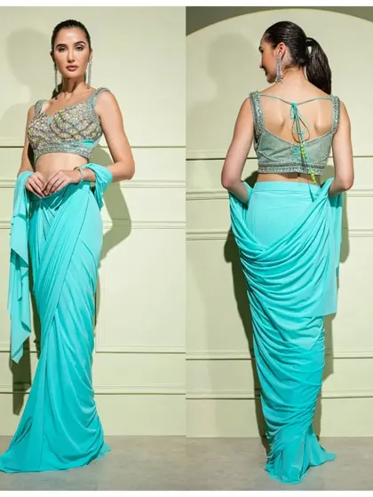 A front and back view of the vibrant turquoise drape saree. The intricate embroidery on the blouse and the unique draping at the back make it a standout piece.