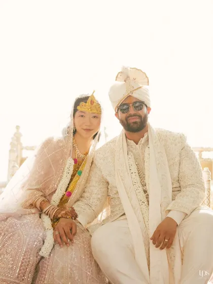 A cool and stylish portrait of the couple in their wedding attire. The groom's sunglasses add a modern touch to this traditional portrait.